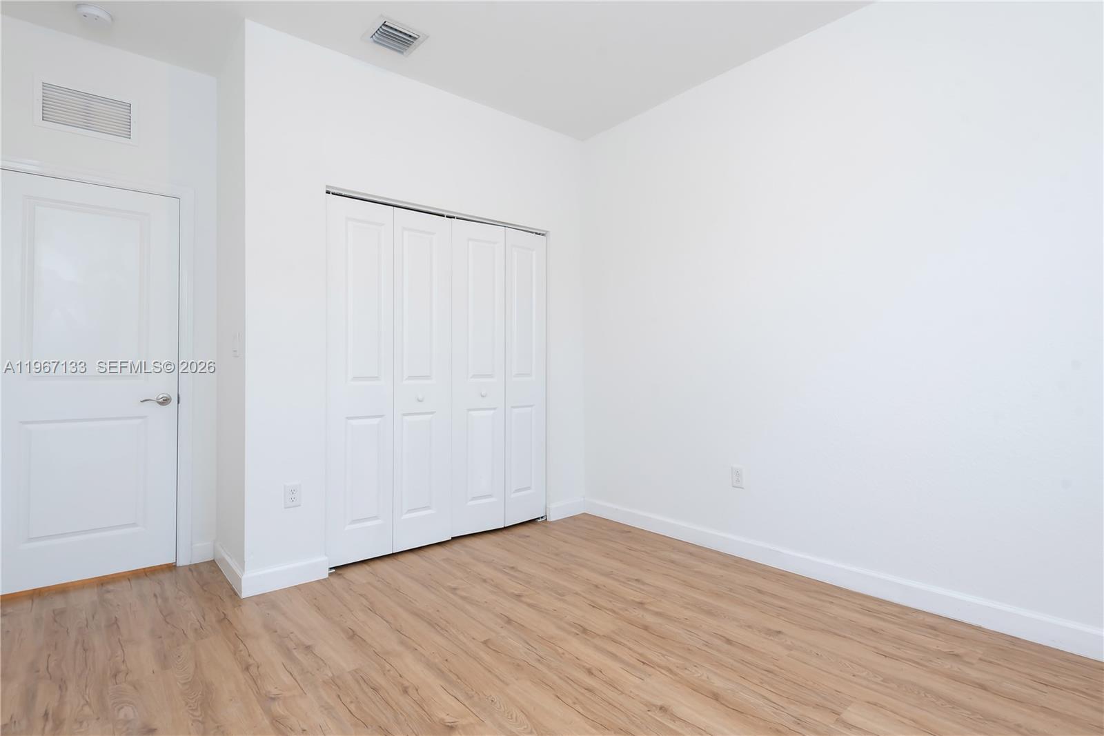 25128 Southwest 113th Place Homestead, FL 33032 - Photo 35 of 39 a view of an empty room with wooden floor