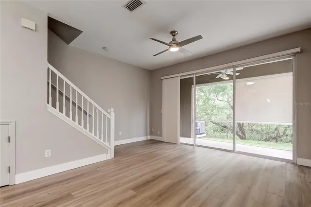 wooden floor in an empty room with a window