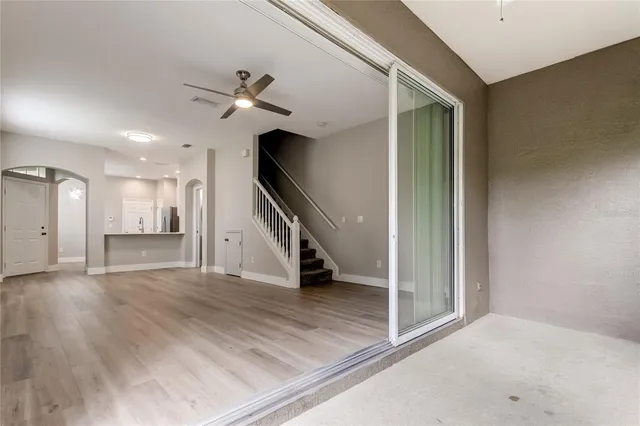 a view of an empty room with a ceiling fan