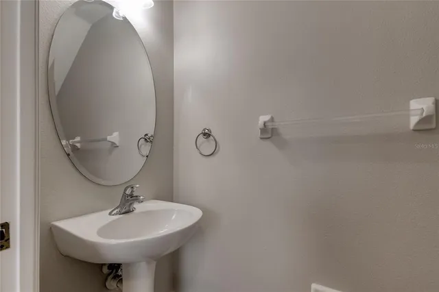 a bathroom with a sink a toilet and mirror