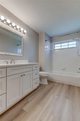 a spacious bathroom with double vanity a toilet a and a double vanity