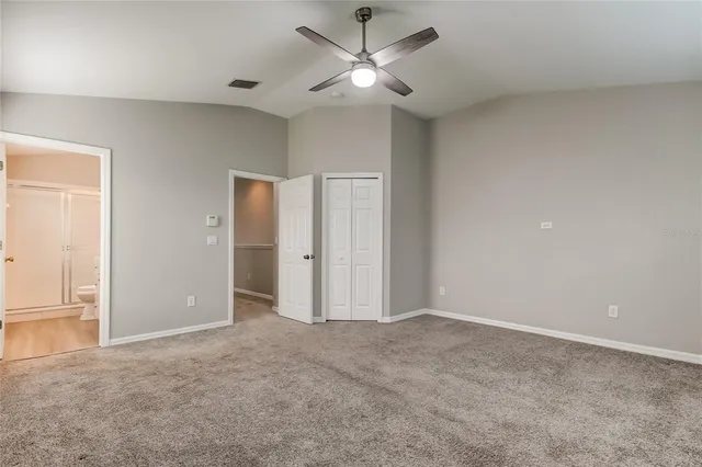 a view of an empty room and a ceiling fan