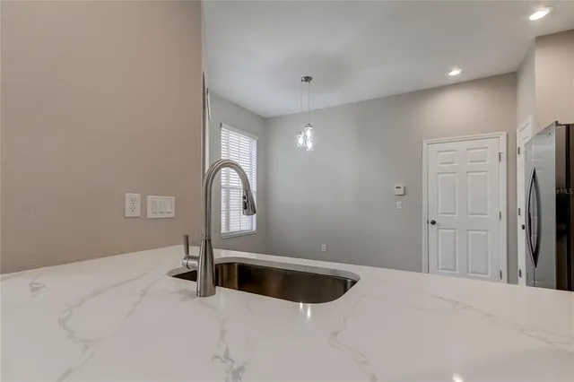 a kitchen with sink and refrigerator