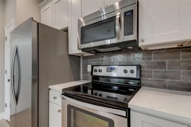 a kitchen with a stove microwave and refrigerator