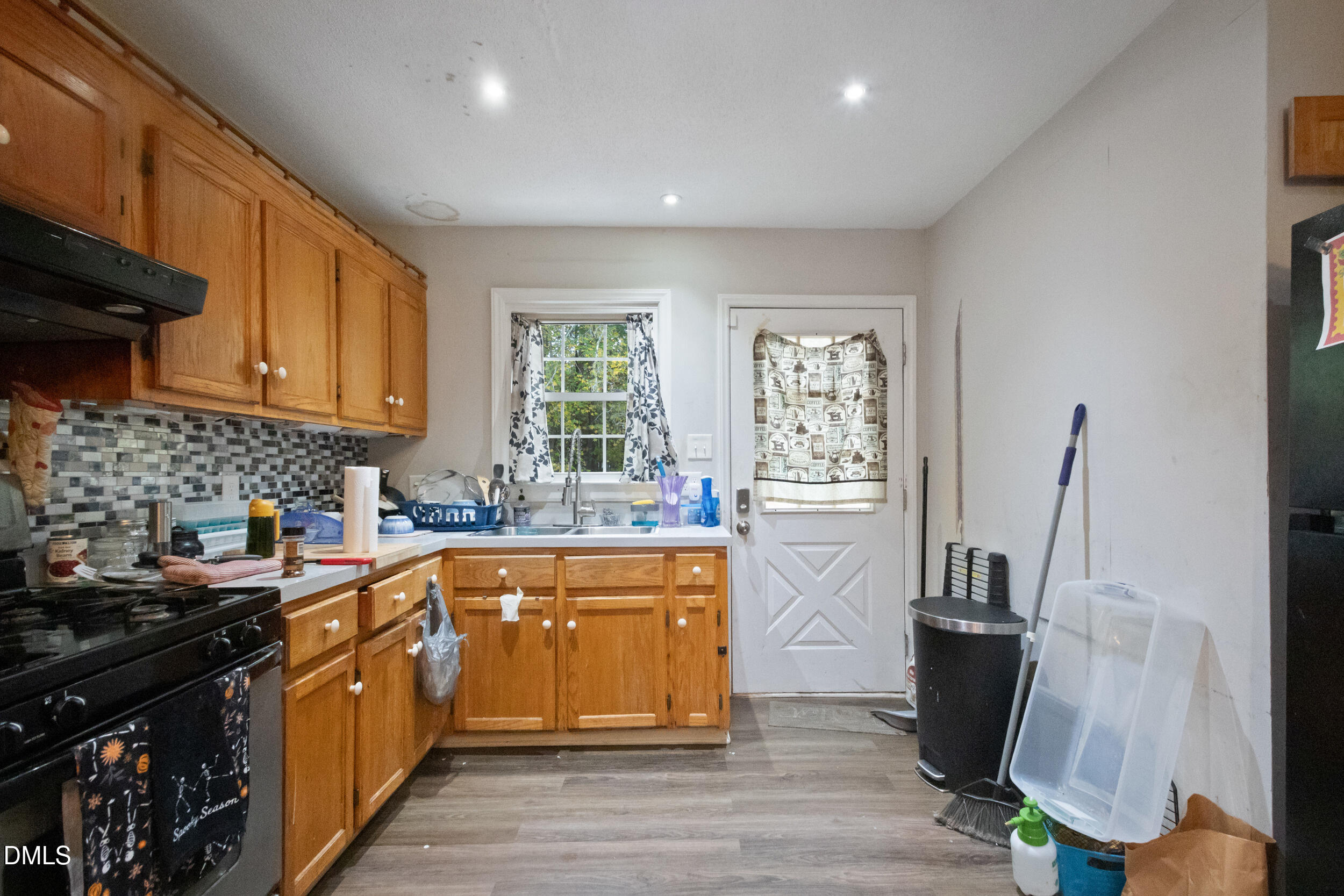 2930 Thomas Road Henderson, NC 27537 - Photo 2 of 17 a kitchen with stainless steel appliances granite countertop a sink stove and refrigerator