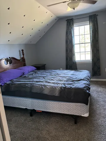 a bedroom with a bed and window