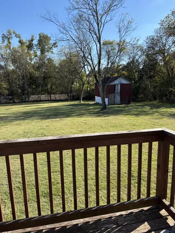 a view of a wooden deck with a backyard