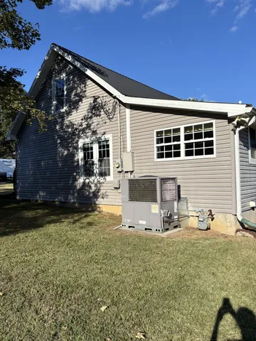 a view of a house with backyard and sitting area