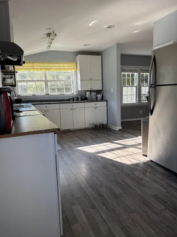 a kitchen with stainless steel appliances a refrigerator and a stove top oven