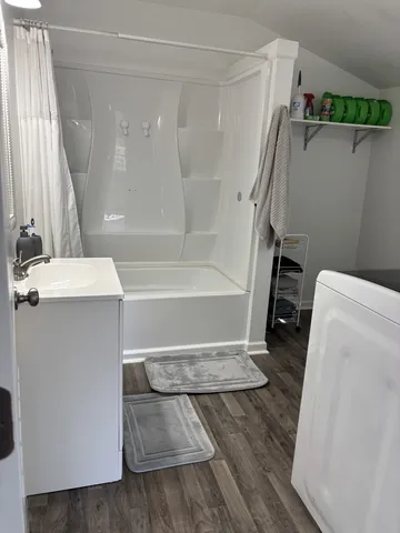 a bathroom with a tub and a sink