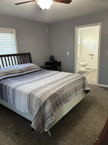 a large bed sitting in a bedroom next to a window