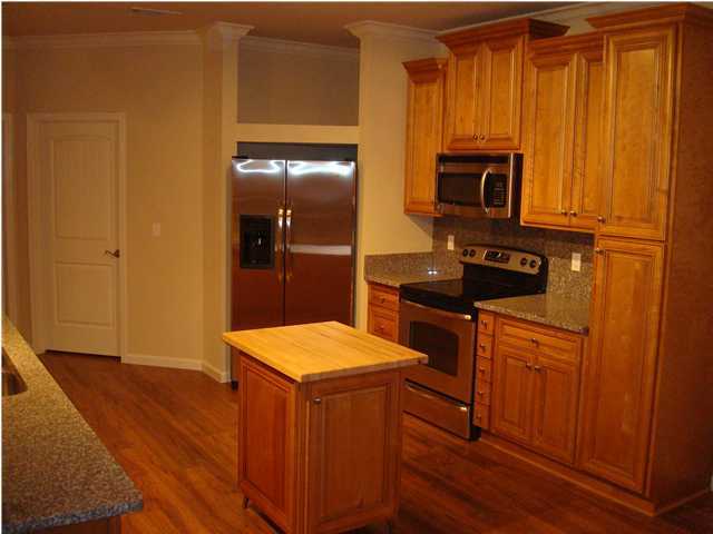 5237 Moore Loop Crestview, FL 32536 - Photo 3 of 17 a kitchen with a refrigerator and a stove top oven