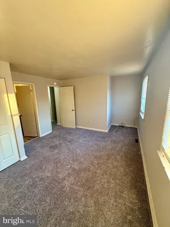 a view of an empty room and a window