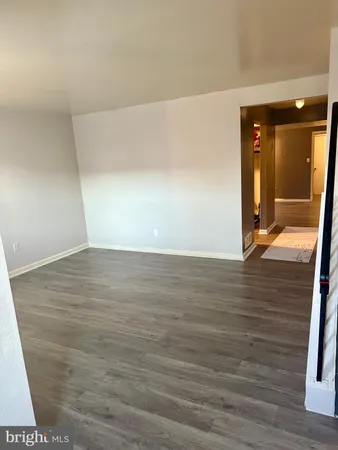 a view of hallway with wooden floor