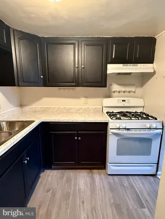 a view of kitchen cabinets and wooden floor