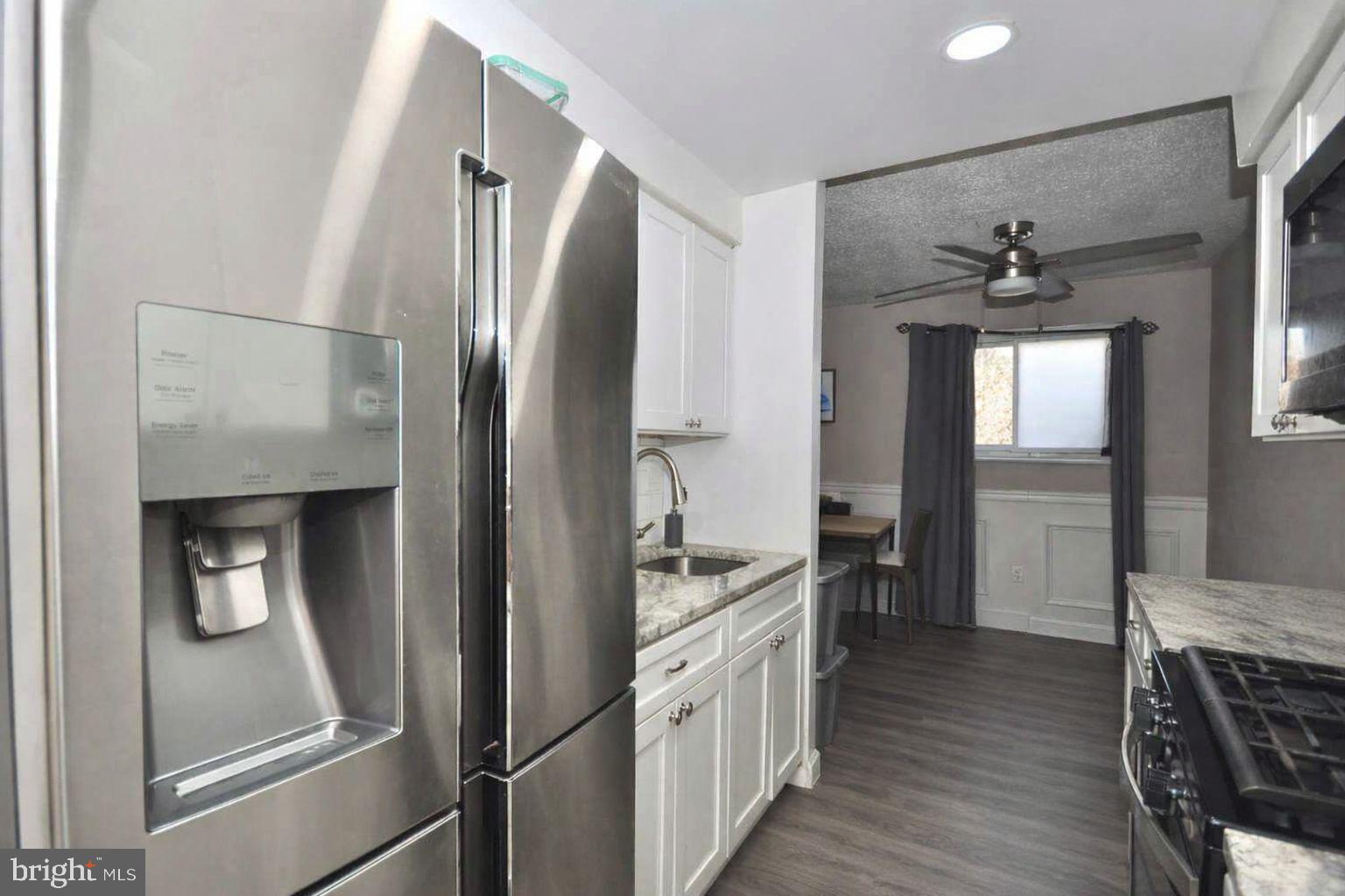 a kitchen with stainless steel appliances a refrigerator and a cabinets