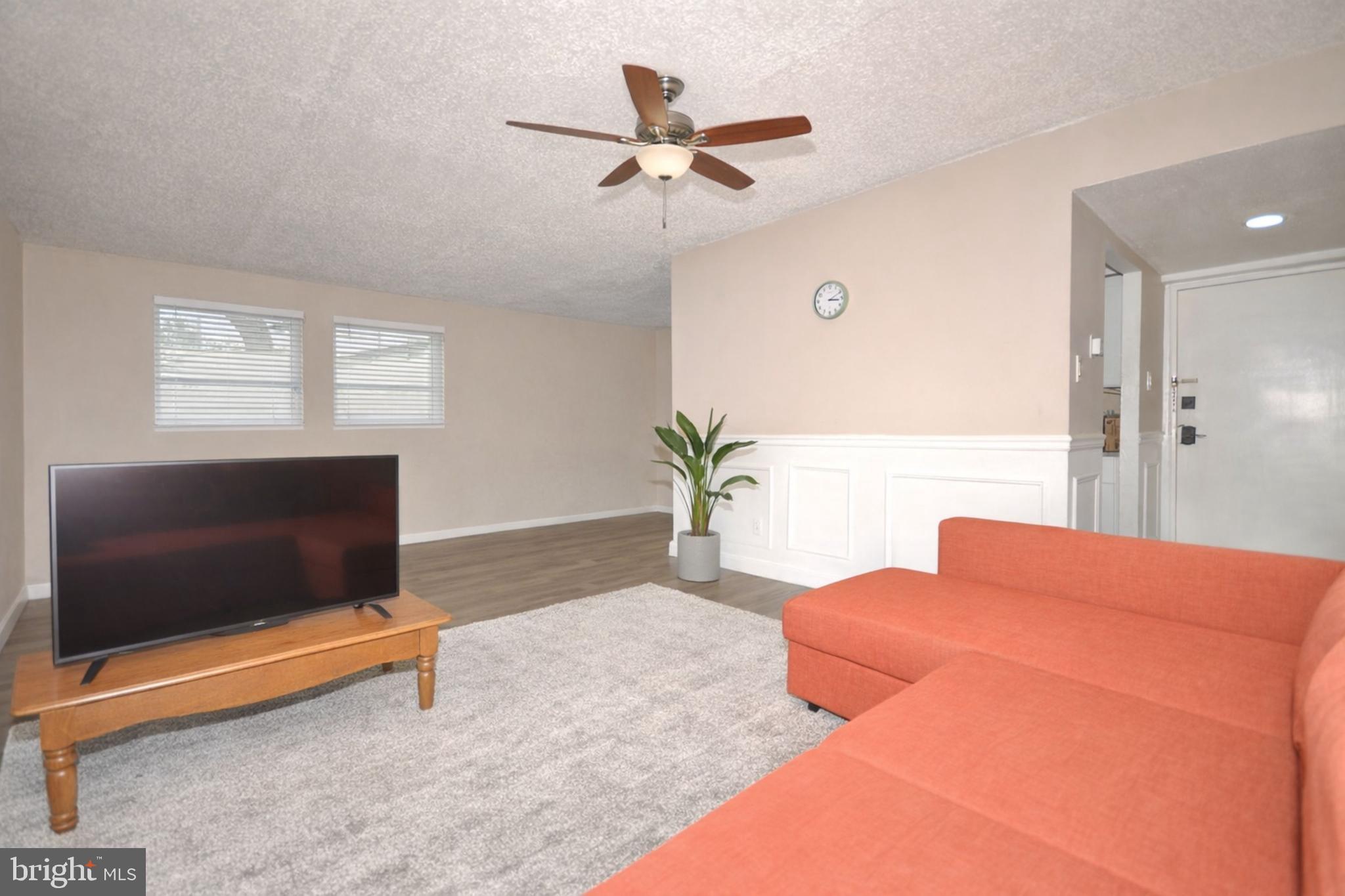 110 Byberry Road, Unit E2 Philadelphia, PA 19116 - Photo 3 of 10 a living room with furniture and a flat screen tv