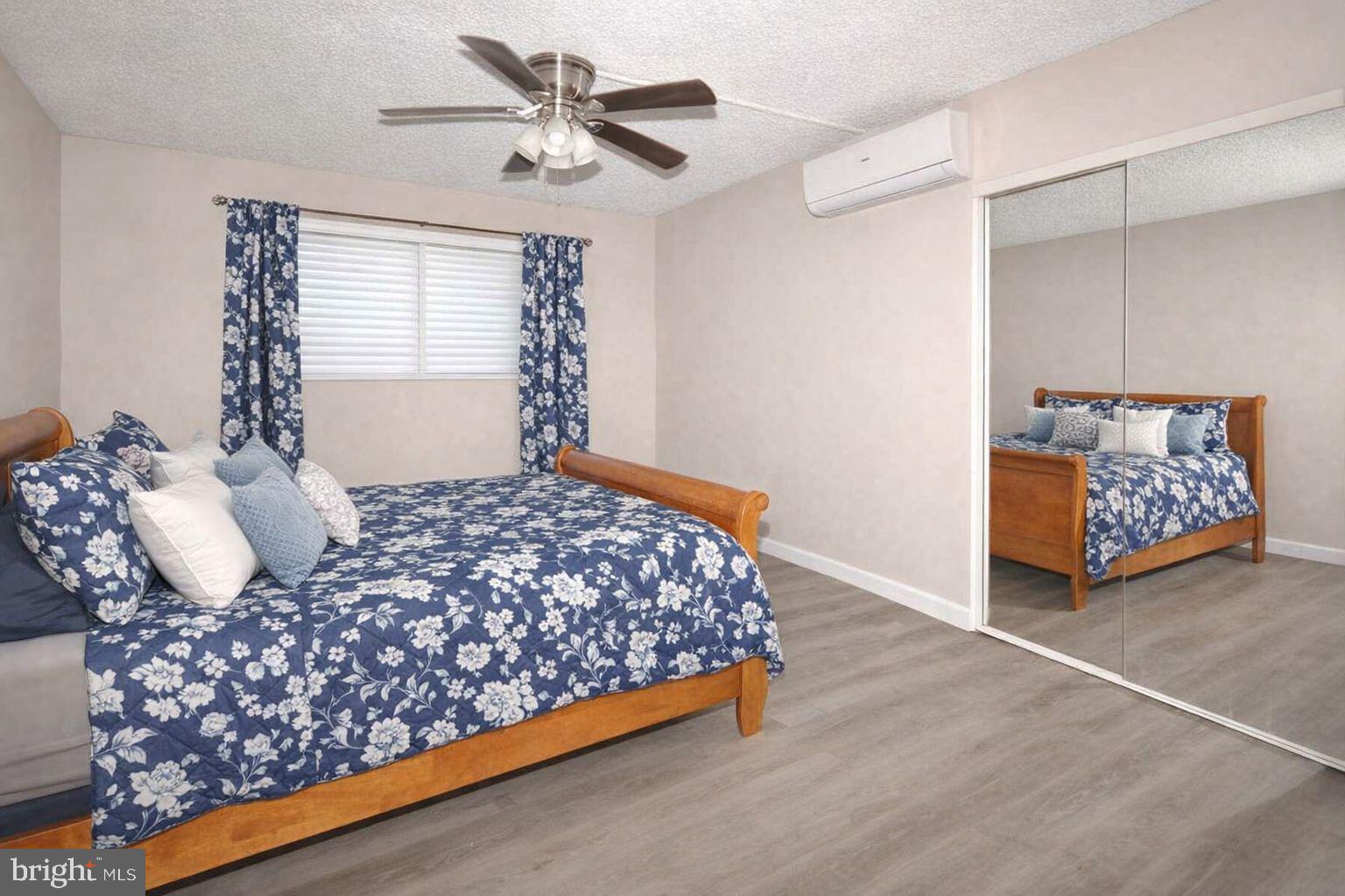 110 Byberry Road, Unit E2 Philadelphia, PA 19116 - Photo 7 of 10 a bedroom with a bed and a chandelier