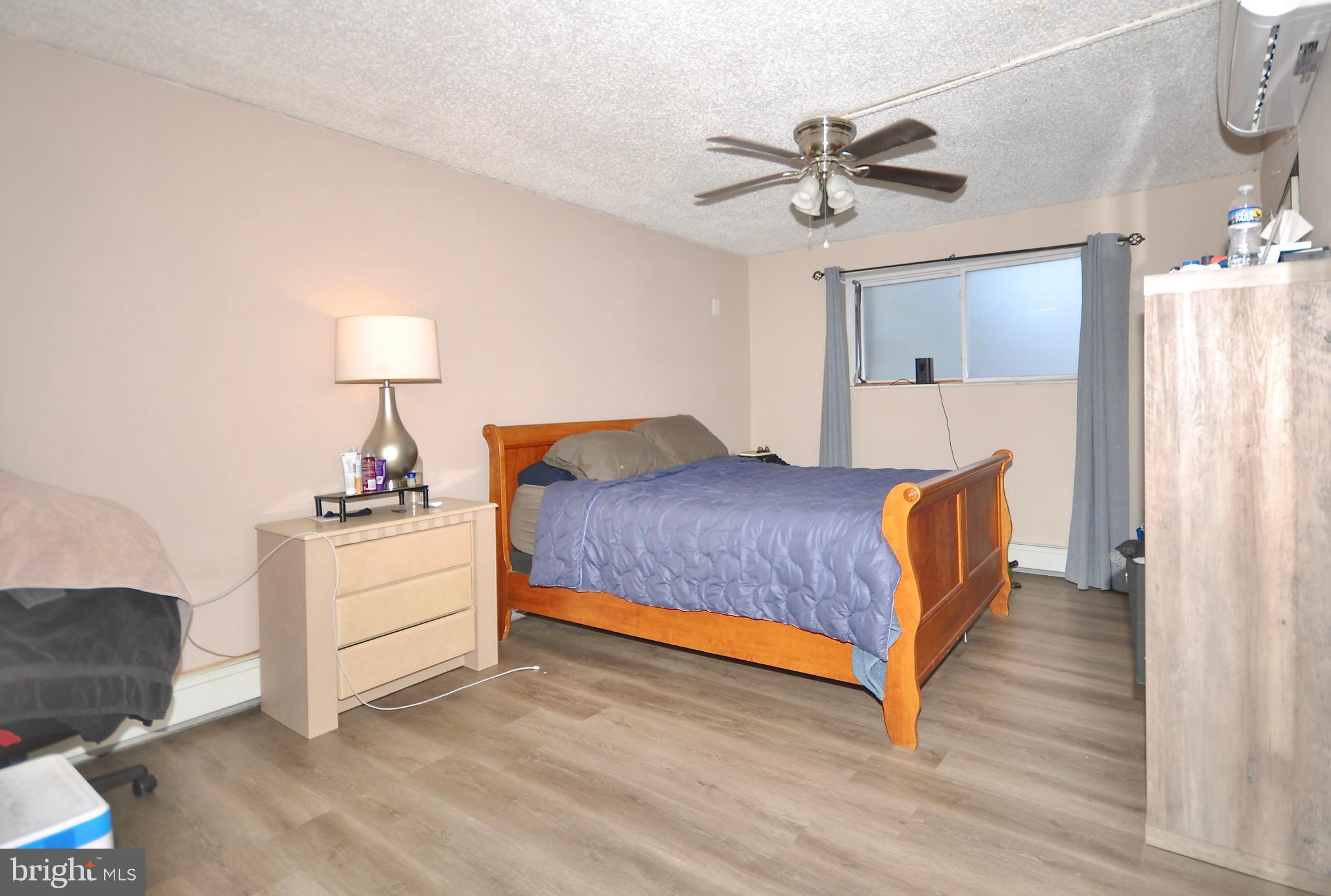 110 Byberry Road, Unit E2 Philadelphia, PA 19116 - Photo 8 of 10 a bedroom with a bed and a chandelier
