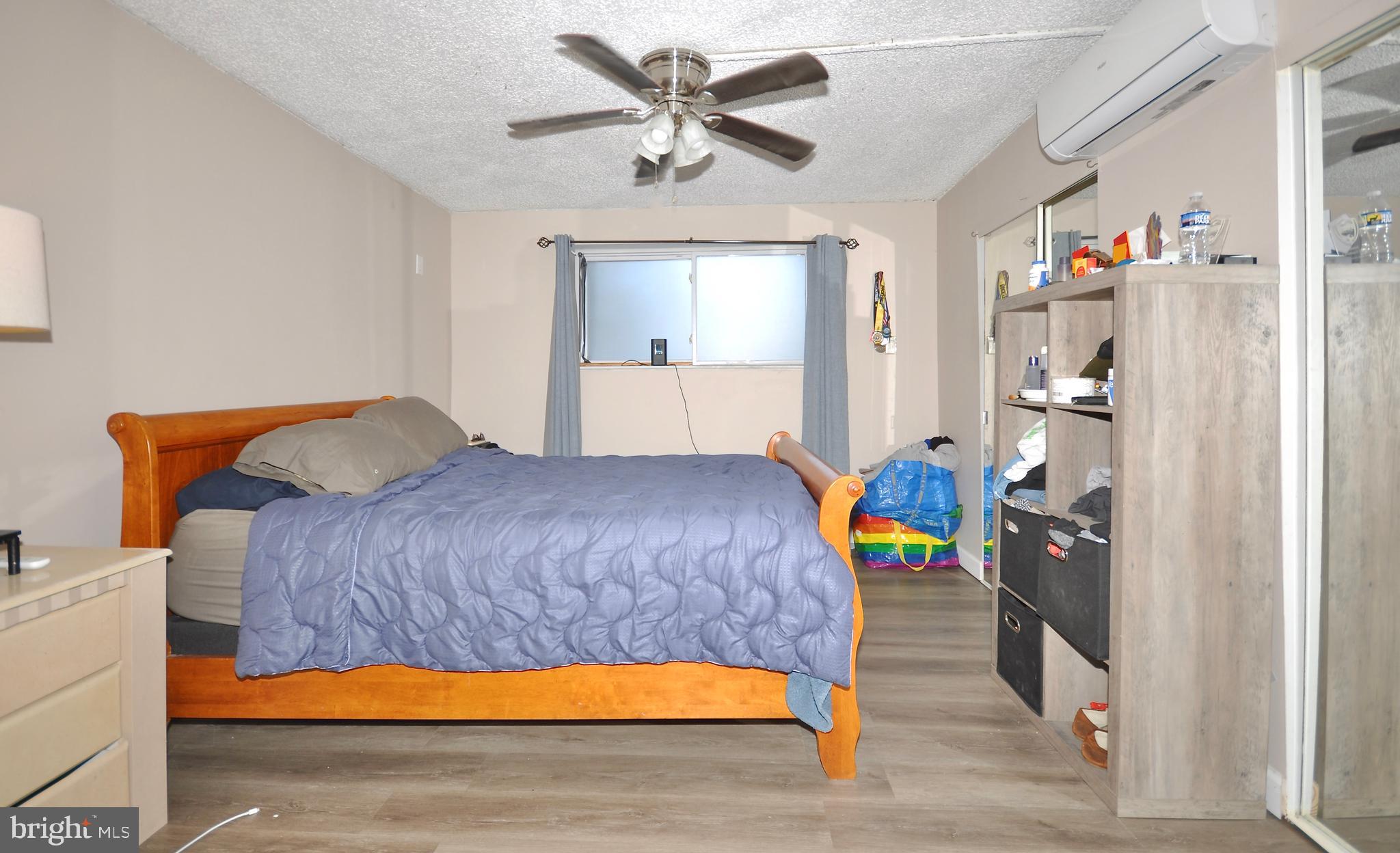 110 Byberry Road, Unit E2 Philadelphia, PA 19116 - Photo 9 of 10 a bedroom with a bed and a chandelier