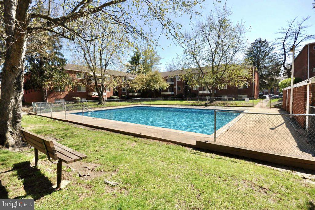 110 Byberry Road, Unit E2 Philadelphia, PA 19116 - Photo 10 of 10 a view of swimming pool with seating area and trees around