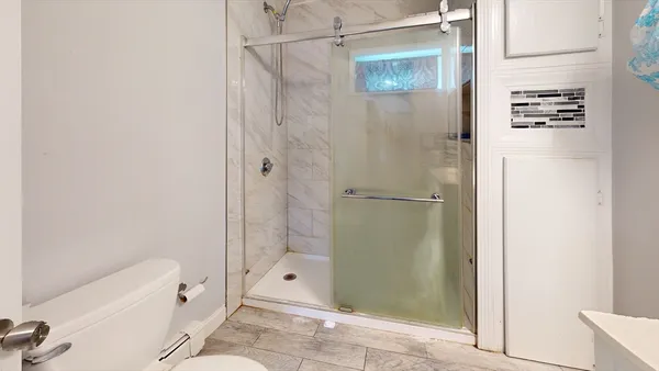 a bathroom with a shower and a tub