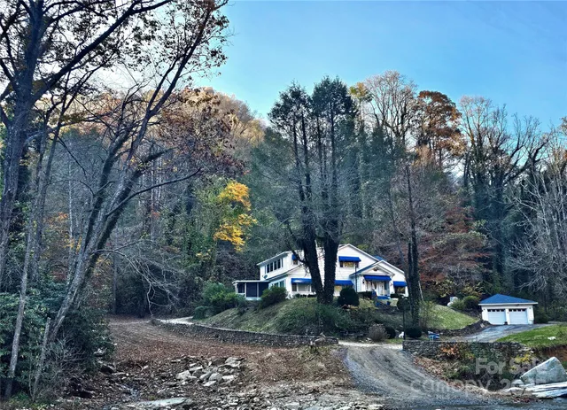 a front view of a house with a yard and garden