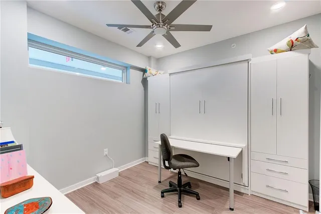a wooden bench sitting in front of a building