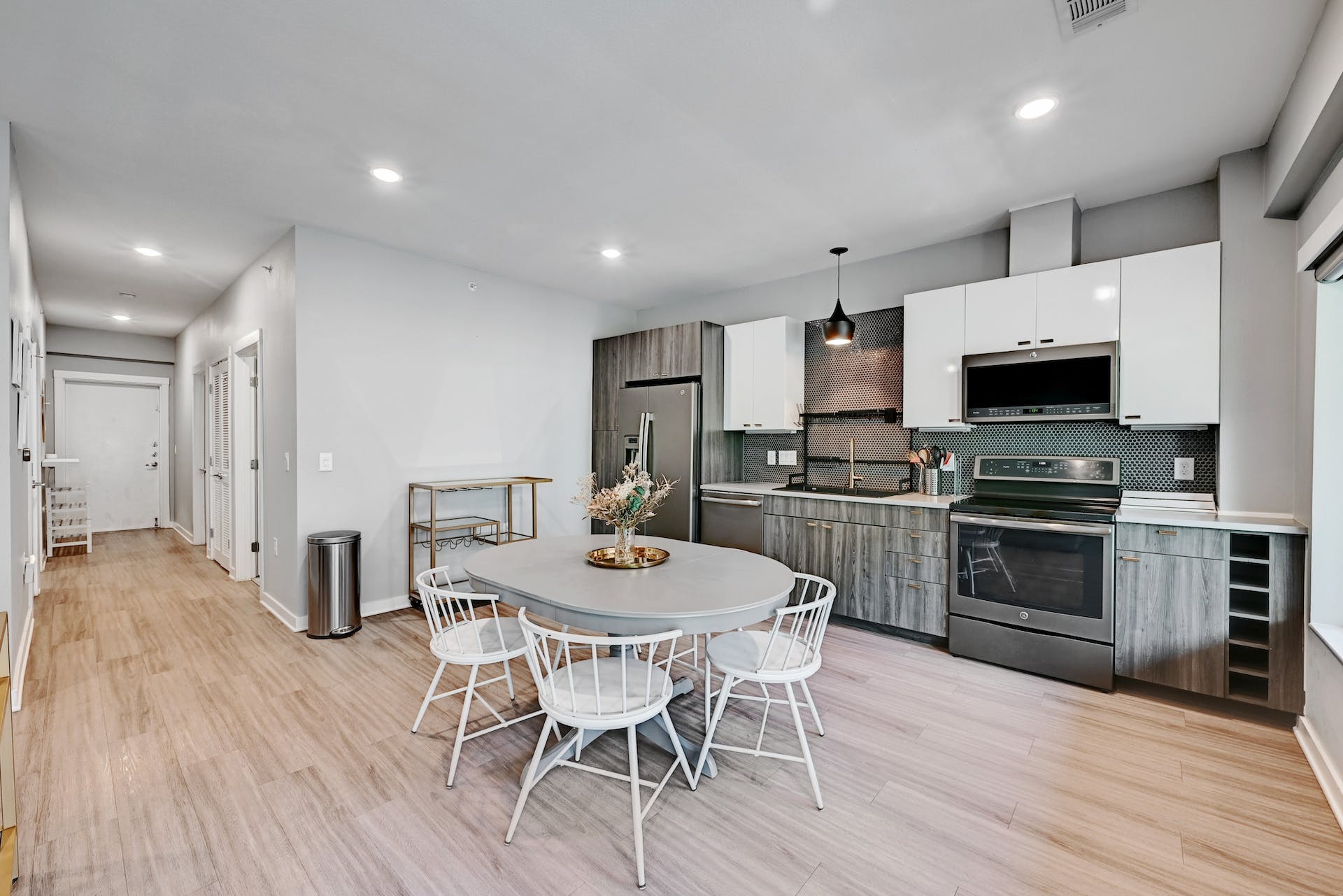 4361 South Congress Avenue, Unit 336 Austin, TX 78745 - Photo 6 of 30 a kitchen with stainless steel appliances a kitchen island hardwood floor and a sink