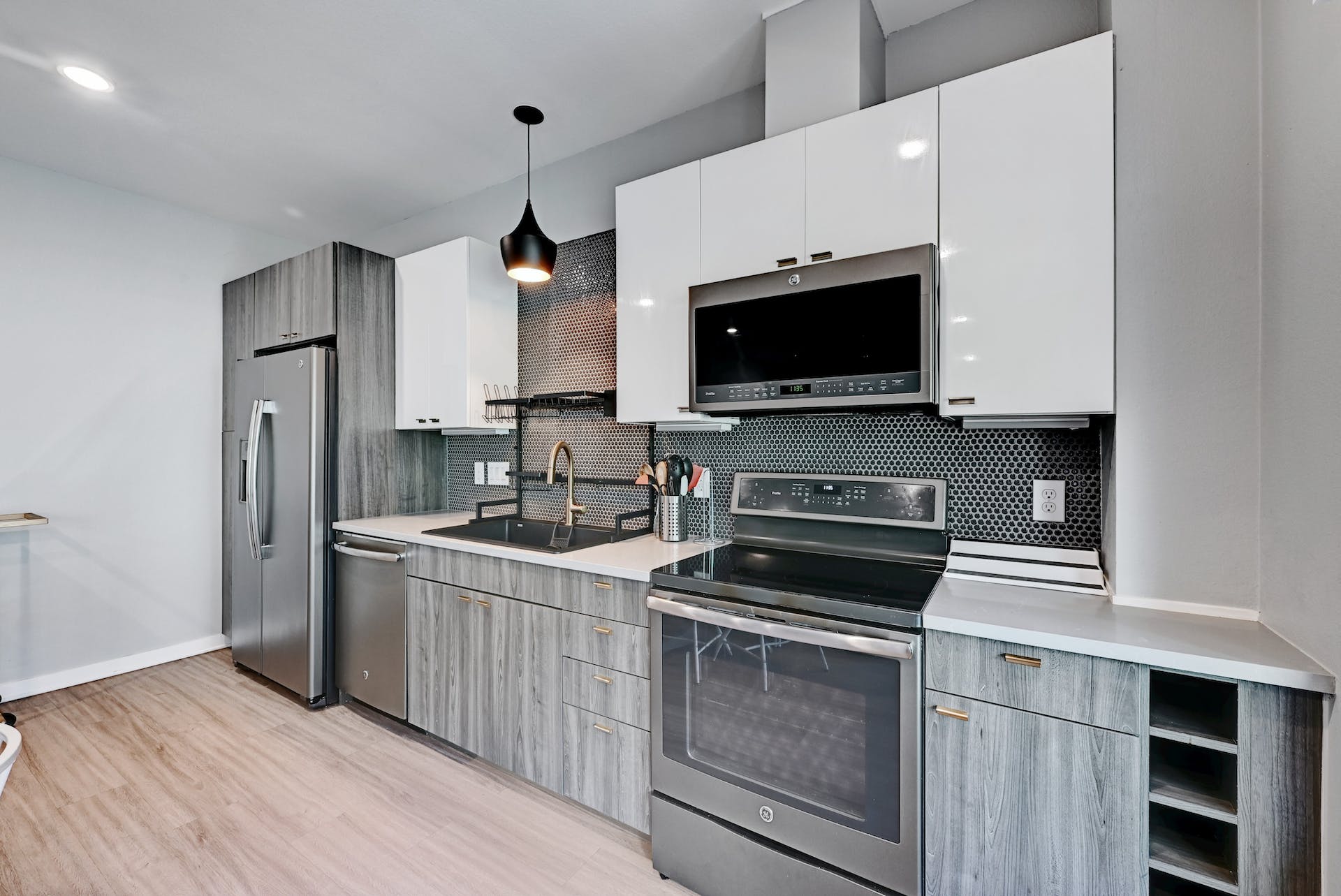 4361 South Congress Avenue, Unit 336 Austin, TX 78745 - Photo 7 of 30 a kitchen with stainless steel appliances a stove a microwave and a sink