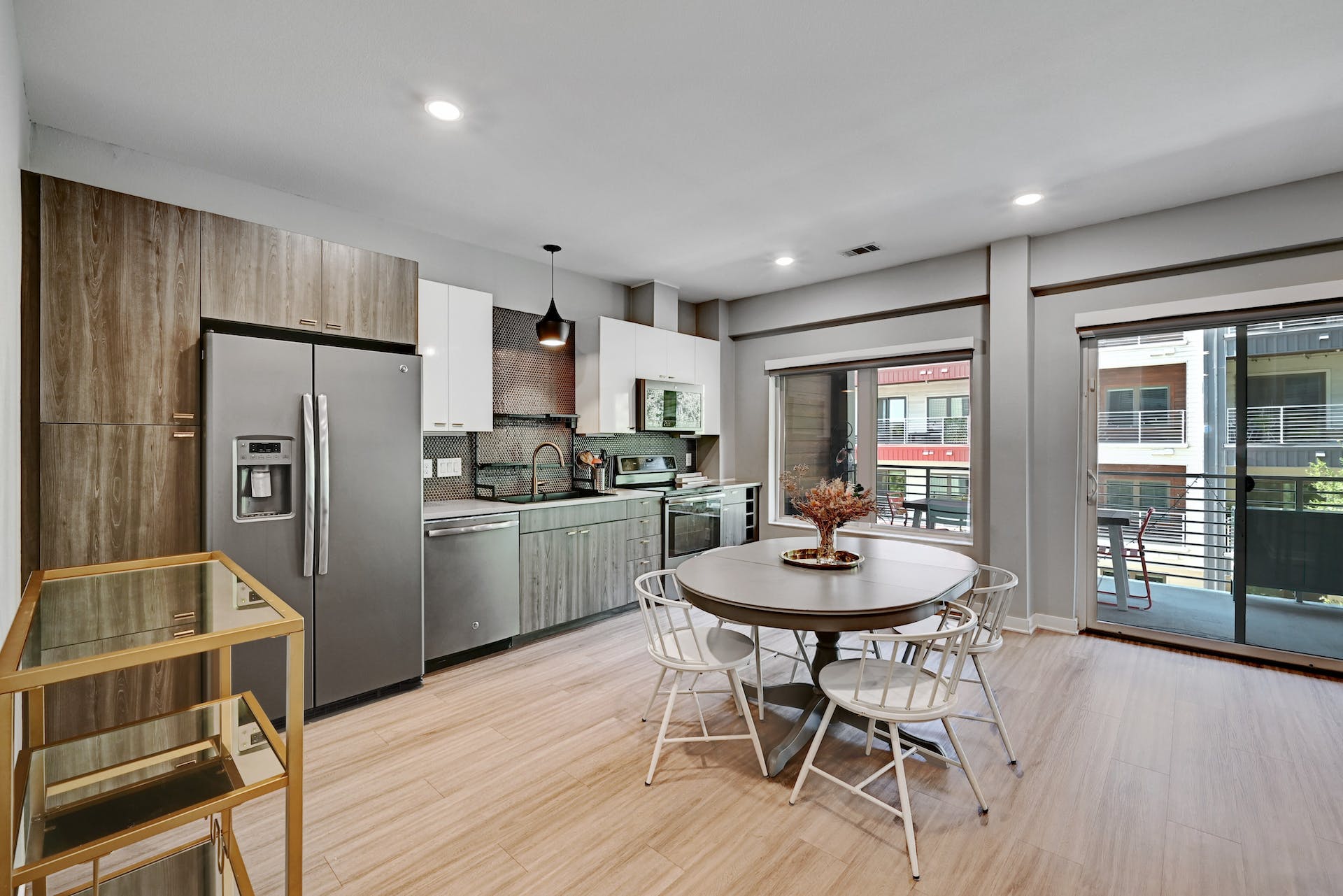 4361 South Congress Avenue, Unit 336 Austin, TX 78745 - Photo 8 of 30 a kitchen with stainless steel appliances a dining table chairs refrigerator and cabinets