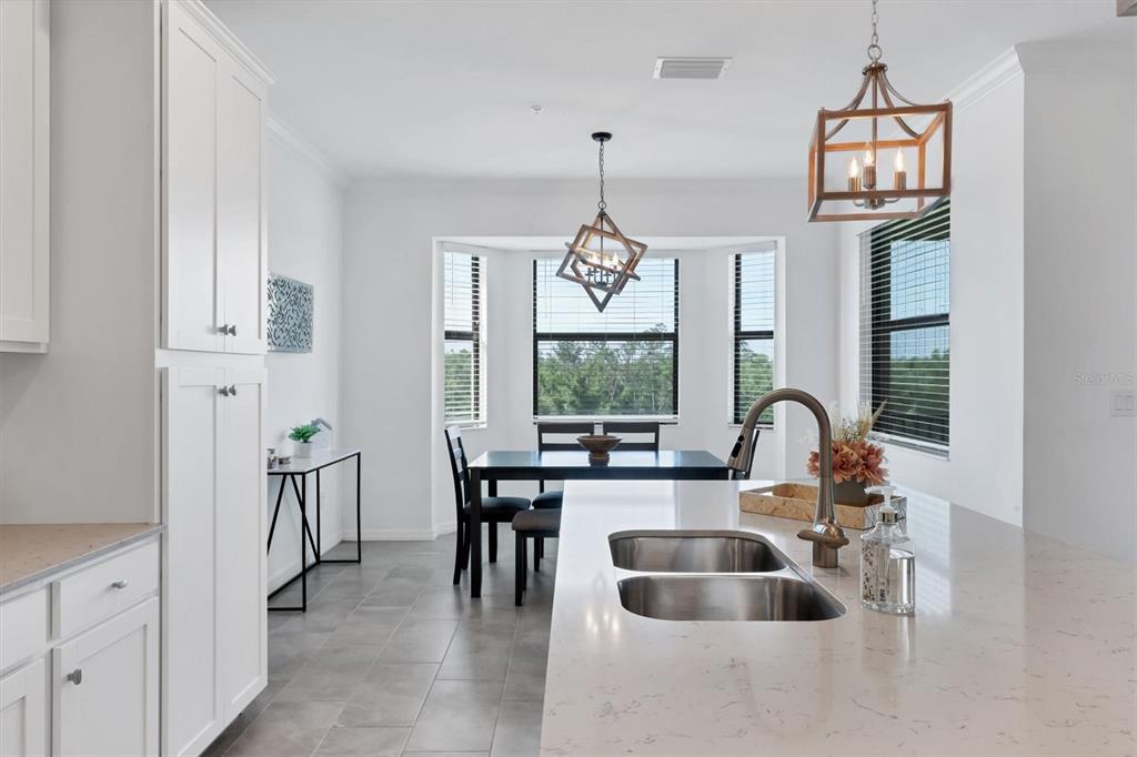 18114 Gawthrop Drive, Unit 405 Bradenton, FL 34211 - Photo 16 of 72 a very nice looking dining room with a large window cabinets and stainless steel appliances