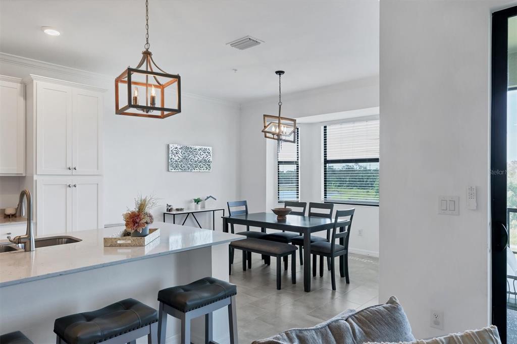 18114 Gawthrop Drive, Unit 405 Bradenton, FL 34211 - Photo 17 of 72 a view of a dining room with furniture window and outside view