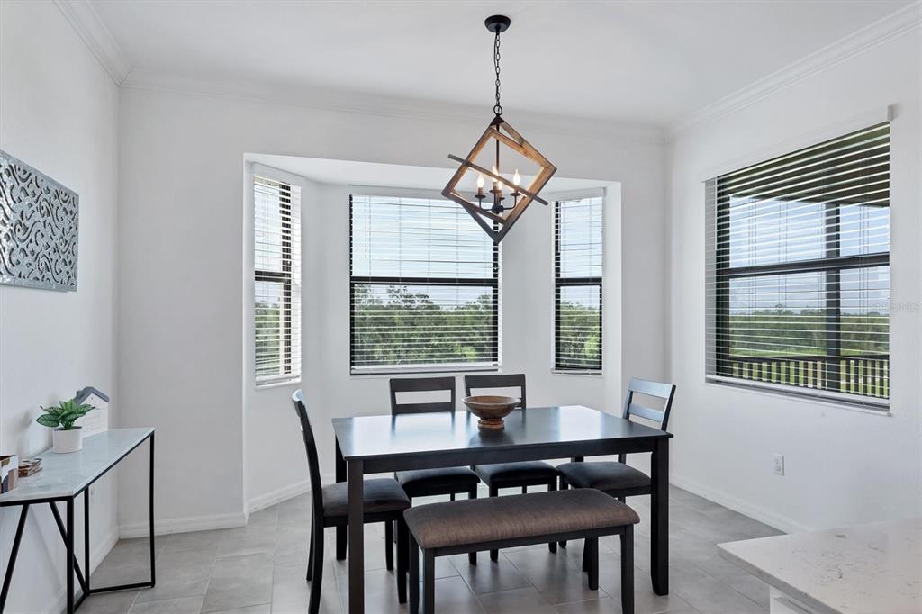 18114 Gawthrop Drive, Unit 405 Bradenton, FL 34211 - Photo 18 of 72 a dining room with furniture a chandelier and wooden floor
