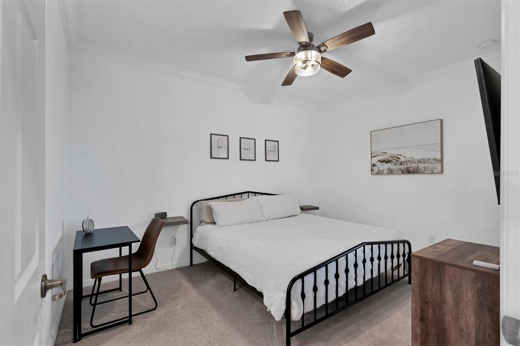 18114 Gawthrop Drive, Unit 405 Bradenton, FL 34211 - Photo 19 of 72 a bedroom with a bed and a chandelier