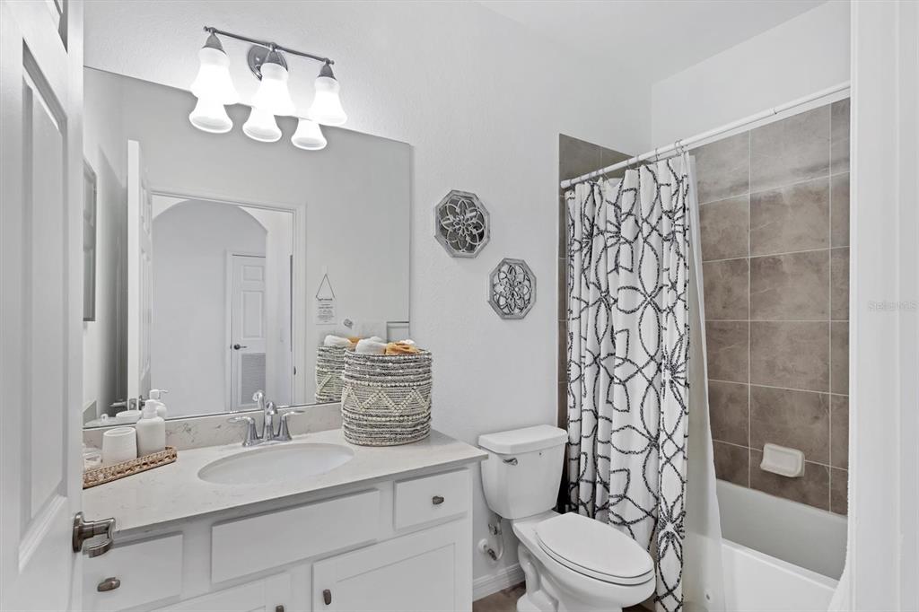 18114 Gawthrop Drive, Unit 405 Bradenton, FL 34211 - Photo 23 of 72 a bathroom with a sink a toilet a mirror a vanity and shower