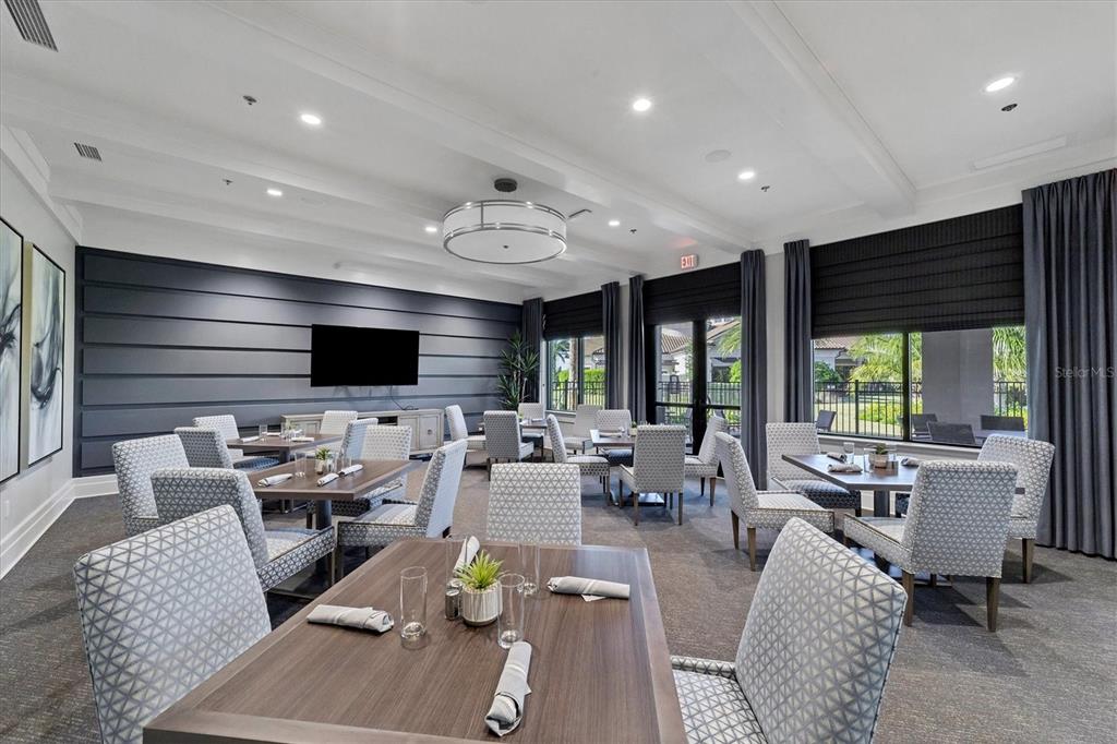 18114 Gawthrop Drive, Unit 405 Bradenton, FL 34211 - Photo 40 of 72 a living room with furniture flat screen tv and a large window
