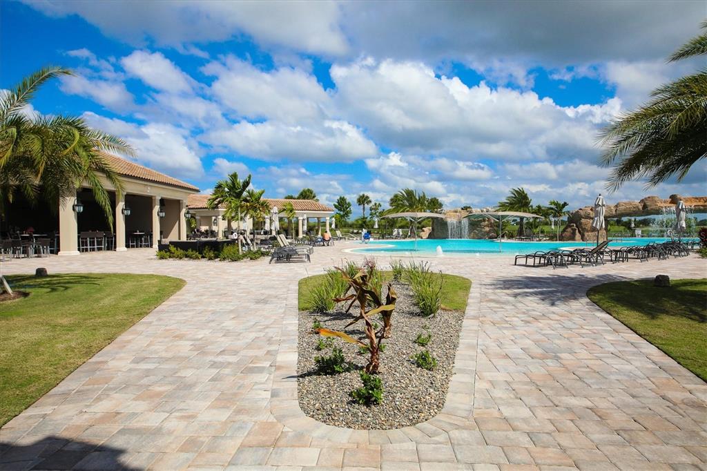 18114 Gawthrop Drive, Unit 405 Bradenton, FL 34211 - Photo 48 of 72 a swimming pool with outdoor seating and garden