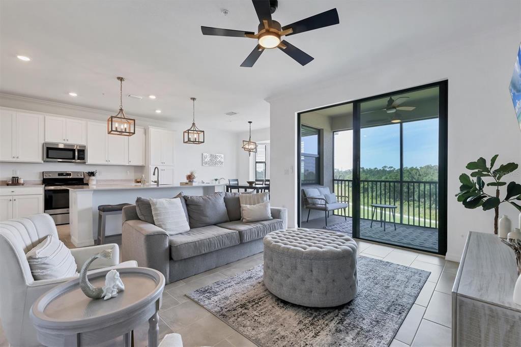 18114 Gawthrop Drive, Unit 405 Bradenton, FL 34211 - Photo 8 of 72 a living room with furniture and a large window
