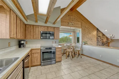 a kitchen with a stove a sink and a microwave