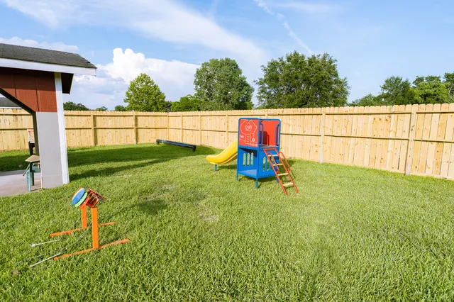 a view of yard with small play house and slide
