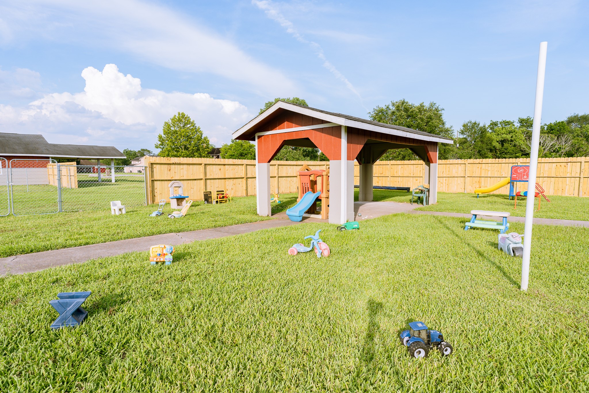 5111 Powerline Road Richmond, TX 77469 - Photo 19 of 22 a view of a house with a yard and a table and chairs