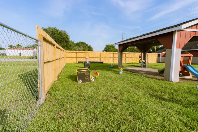 a backyard of a house with table and chairs
