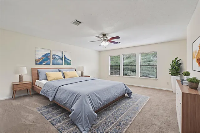 a bedroom with a large bed and a large window