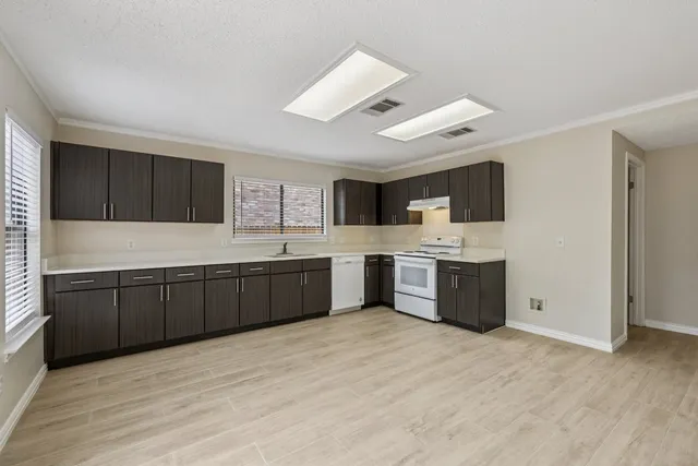 a large kitchen with a large window and cabinets