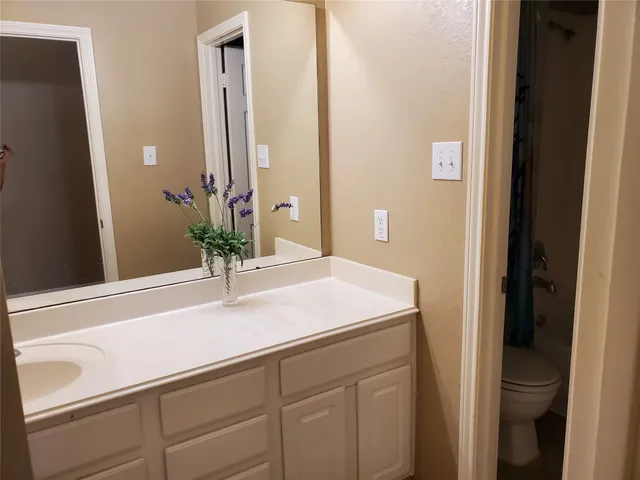 a view of a hallway with wooden floor and a fireplace