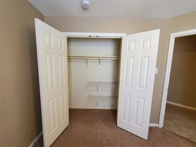 a bathroom with a double vanity sink a large mirror and a bathtub