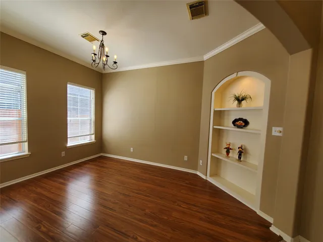 a view of a livingroom with wooden floor and window