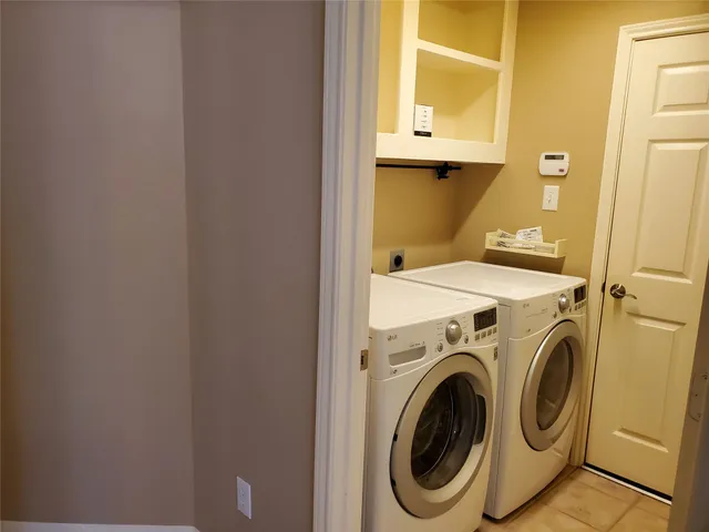 a kitchen with granite countertop white cabinets and black appliances