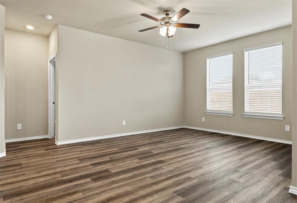 15932 Stableford Road Justin, TX 76247 - Photo 12 of 35 Spacious room featuring wood-finish flooring, neutral-toned walls, and a ceiling fan